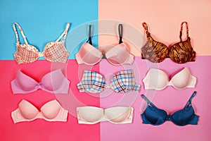 Set of different bras on multicolored background