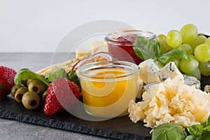 Set of different cheese appetizer on light gray background.