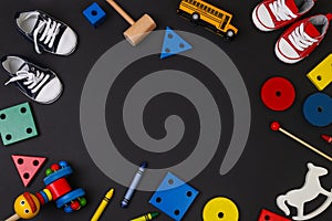 Set of different children`s toys on a black background top view. A place to insert text, minimalism. Baby background