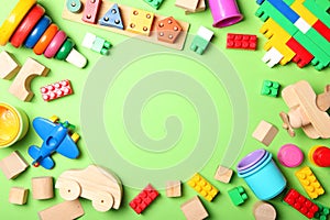 Set of different children's toys on a colored background top view.