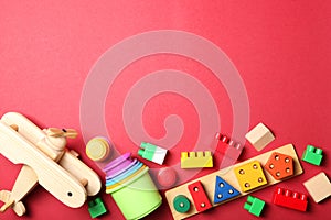 Set of different children's toys on a colored background top view.