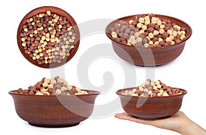 set of different Chocolate breakfast cereal in bowl with hand, isolated on white background, brown and white balls, healthy mornin