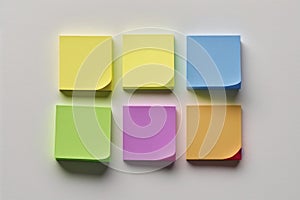 Set of different colored sticky notes on white wall background