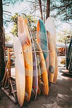 Set of different colorful surf boards in a stack