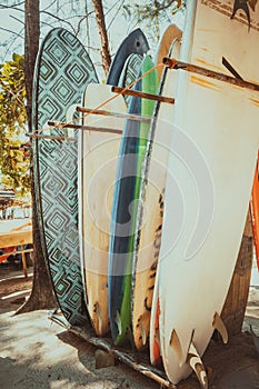 Set of different colorful surf boards in a stack