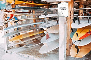 Set of different colorful surf boards in a stack photo