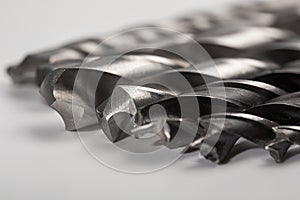 Set of different drill bits on white background