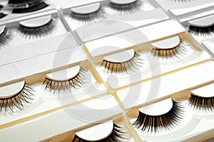 Set with different false eyelashes in packs as background