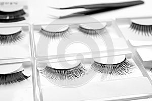 Set with different false eyelashes in packs as background