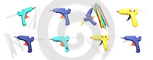 Set with different glue guns with sticks on white background, top view. Banner design