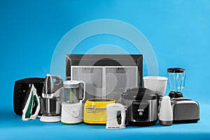 Set of different household appliances on blue background