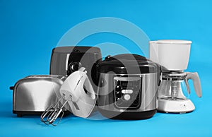 Set of different household appliances on blue background