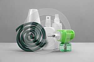 Set of different insect repellents on grey background
