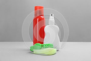 Set of different insect repellents on grey background