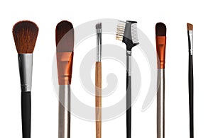 Set with different makeup brushes for applying cosmetic products on white background