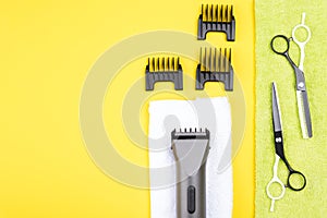 set of different objects for hair cutting, lies on a yellow background, there is a place for an inscription