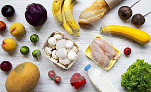 Set of different organic food on white wooden table, top view. Cooking food background.