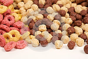 A set of different quick breakfast cereals - rings and balls, top view on white.