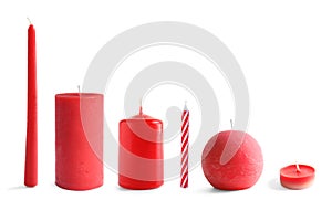 Set with different red candles on white