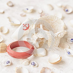 Set of different seashells and bracelet with anchor, summer composition. Summer vacation concept