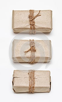 Set of different sides of the same parcel wrapping in brown craft paper and tie hemp string. Package. Delivery service.