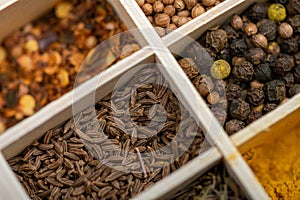 A set of different spices in a wooden box. Close-up, selective focus