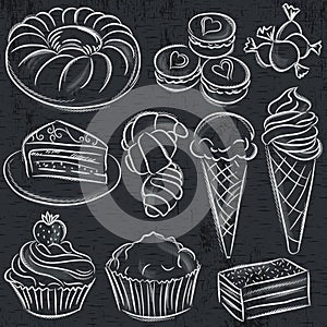 Set of different sweetmeats on blackboard photo