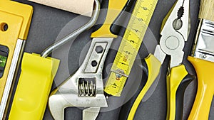 Set of different tools for home renovation or DIY on grey background. closeup top view