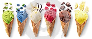 Set of different types of ice cream balls in waffle cones with ice cream ingredients - fruits, berries and sweets