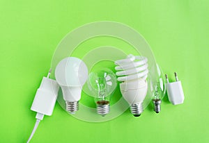 A set of different types of LED lamps isolated on a green background. Energy-saving lamps