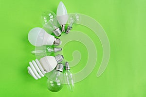 A set of different types of LED lamps isolated on a green background. Energy-saving lamps.