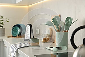 Set of different utensils and dishes on countertop in kitchen