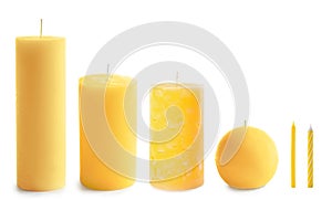 Set with different yellow candles on white
