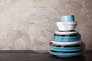 Set of dinnerware on table against grey background with space for text