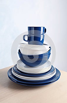 Set of dinnerware on table against light background.