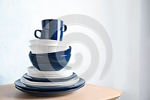 Set of dinnerware on table against light background with space for text.