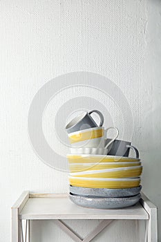 Set of dinnerware on table against light background with space for text