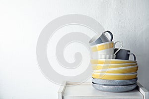 Set of dinnerware on table against light background with space for text.