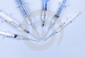 Disposable syringes on blue background