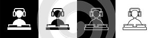 Set DJ wearing headphones in front of record decks icon isolated on black and white background. DJ playing music. Vector
