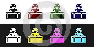 Set DJ wearing headphones in front of record decks icon isolated on black and white background. DJ playing music. Vector