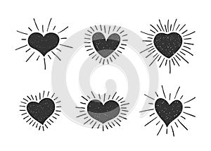 Set of doodle heart shaped symbols with retro styled sun rays. Collection of different hand drawn romantic hearts for