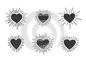 Set of doodle textured heart shapes with retro styled sun rays. Collection of different hand drawn romantic hearts for