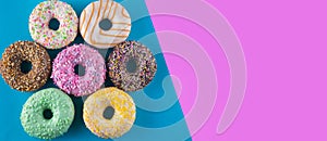 Set of doughnuts on blue and purple background.