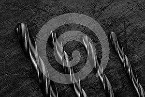 Set of drill bits on wooden background. Symbolic repair tool