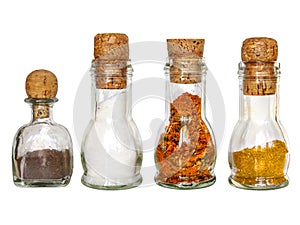 set of dry spices in vintage glass bottles with old wine corc