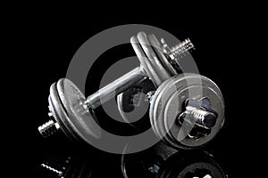 Set of dumbells on black photo