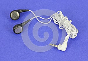 Set of ear buds on blue background