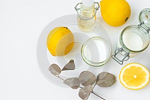 Set of eco cleaning products. Eco sponges, lemons, apple vinegar, citric acid and soda on white background