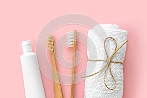 Set of eco-friendly toothbrushes, toothpaste and other tools on pink background.